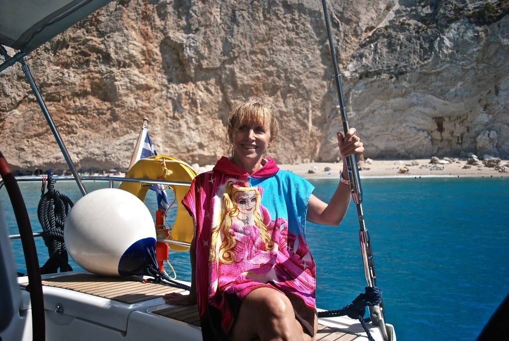 Blonde on a sailboat in a child's towel/robe