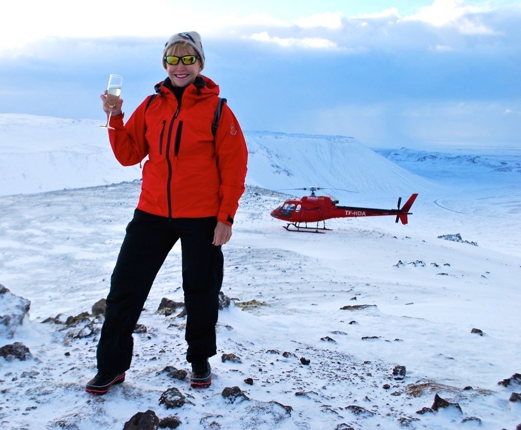 Drinking champagne on Helgafell Summit outside of Reykjavik as part of a helicopter ride in the winter