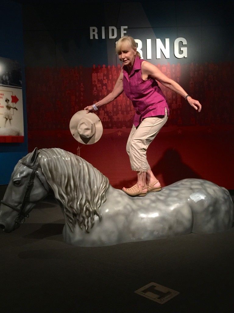 Blonde pretending to ride a horse's back at the Ringling Circus Museum - read on for interesting info about this place.