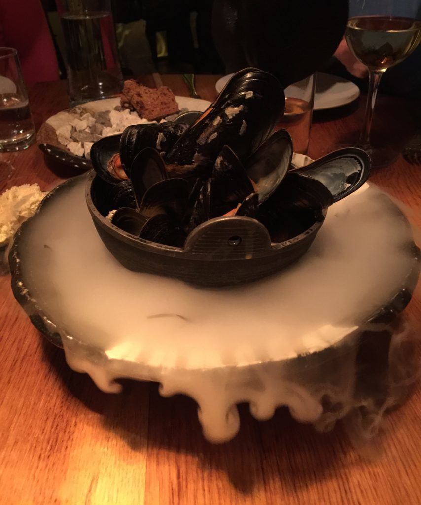 Dramatic lavaesque mussels over dry ice at Fishmarkadurrin, one of the top restaurants in Reykjavik